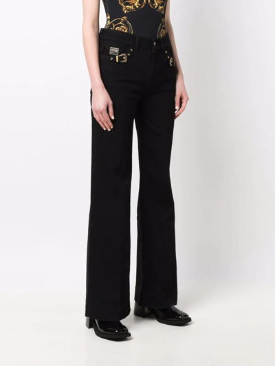 Shop Versace Jeans Couture Buckle-detail Flared Trousers In Black