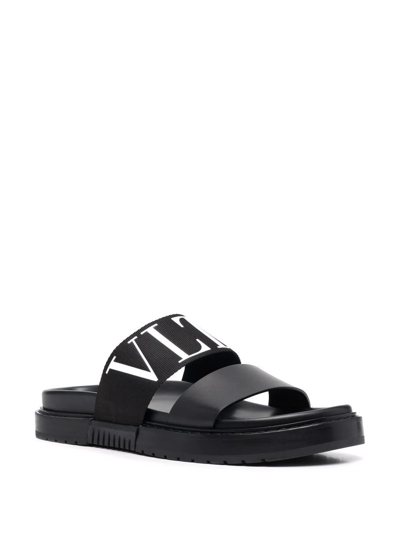 Shop Valentino Logo-embossed Leather Slides In Schwarz