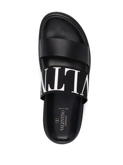 Shop Valentino Logo-embossed Leather Slides In Schwarz