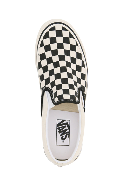 Shop Vans Classic Slip-on Checkerboard Sneakers In White,black