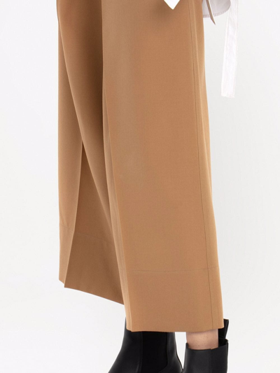 Shop Jw Anderson Pleat-front Wide-leg Cropped Trousers In Brown