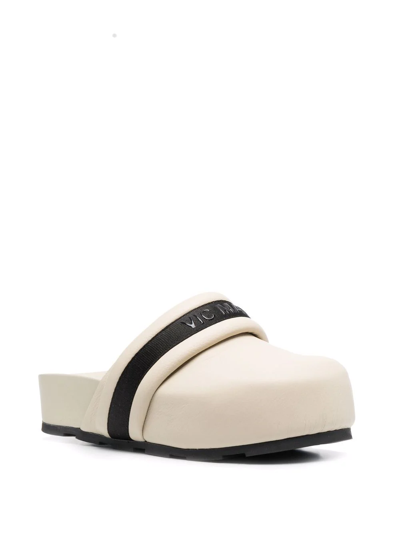 Shop Vic Matie Embossed-logo Leather Mules In Neutrals