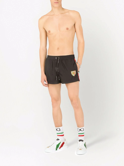 Shop Dolce & Gabbana Side-stripe Logo Swimming Shorts In Schwarz