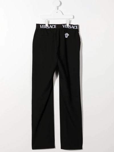 Shop Versace Logo-waistband Straight Trousers In Black