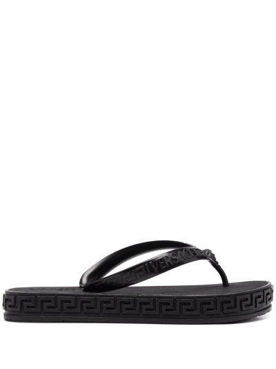 Shop Versace Greca-motif Flip Flops In Schwarz