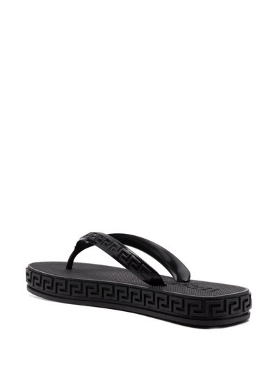 Shop Versace Greca-motif Flip Flops In Schwarz