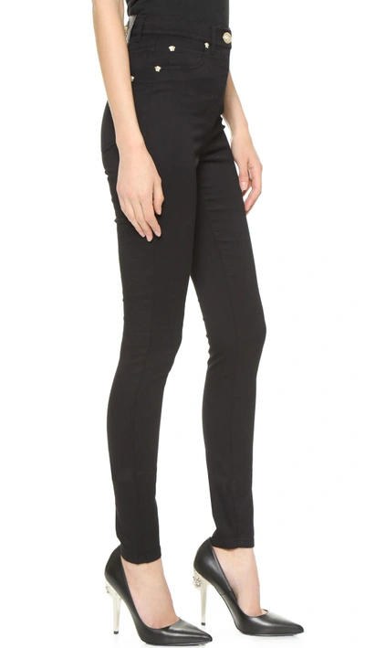 Shop Versace Medusa Stud Skinny Jeans In Black