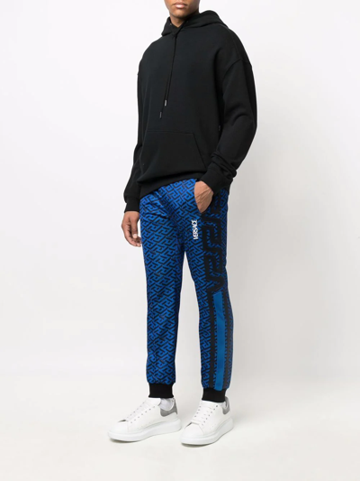 Shop Versace Monogram-print Track Trousers In Blue