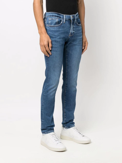 Shop Frame Mid-rise Skinny Jeans In Blue