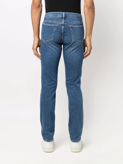 Shop Frame Mid-rise Skinny Jeans In Blue