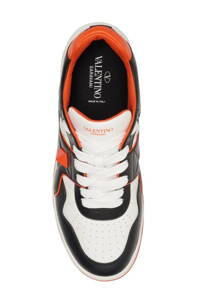 Shop Valentino Roman Stud Low Top Sneaker In Black/ White/ Orange