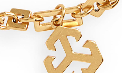 Shop Tory Burch Logo Charm Bracelet In Rolled Brass 59