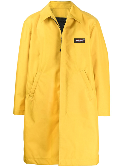 Shop Undercover X Eastpak Back-pocket Coat In Yellow