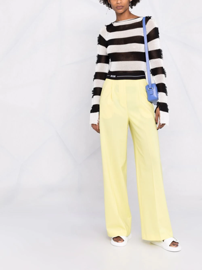 Shop Msgm Logo-waistband Flared Trousers In Gelb