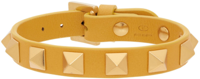 Shop Valentino Yellow Leather Rockstud Bracelet In Golden Yellow