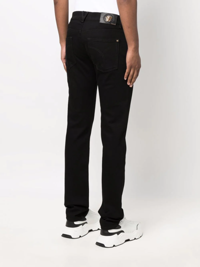 Shop Versace Mid-rise Slim-fit Jeans In Schwarz