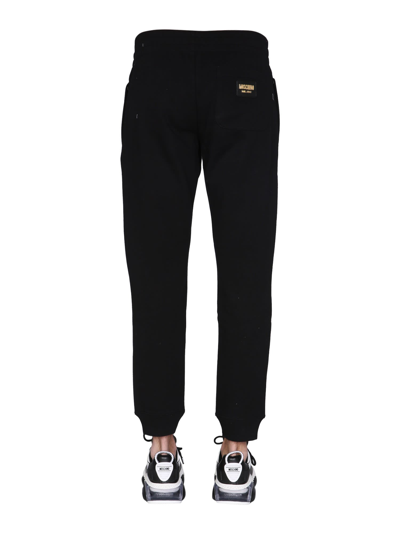 Shop Moschino Jogging Pants With Logo Patch In Nero