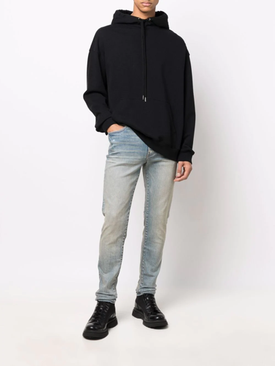 Shop Amiri Logo-patch Stonewashed Skinny Jeans In Blau