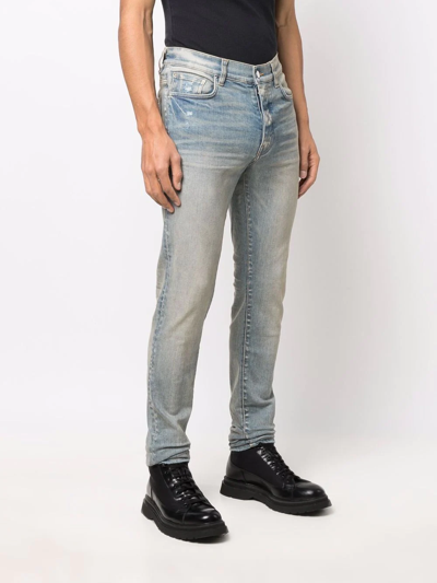 Amiri Logo-patch Stonewashed Skinny Jeans In Blau