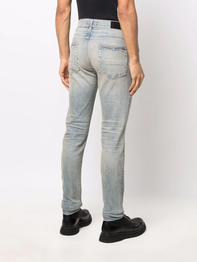 Shop Amiri Logo-patch Stonewashed Skinny Jeans In Blau