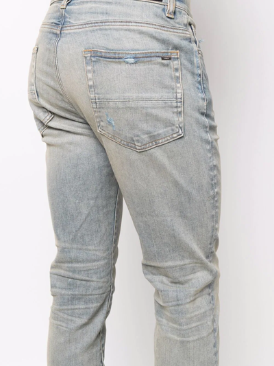 Shop Amiri Logo-patch Stonewashed Skinny Jeans In Blau