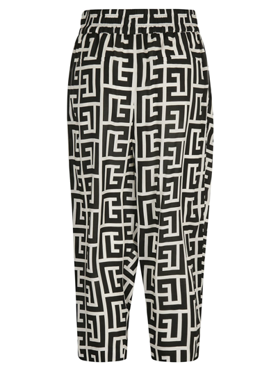 Shop Balmain All-over Logo Cropped Trousers In Ivory/black
