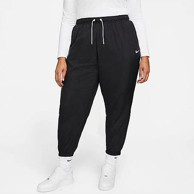 Shop Nike Women's Sportswear Essential Oversized Woven Mid-rise Jogger Pants (plus Size) In Black/white