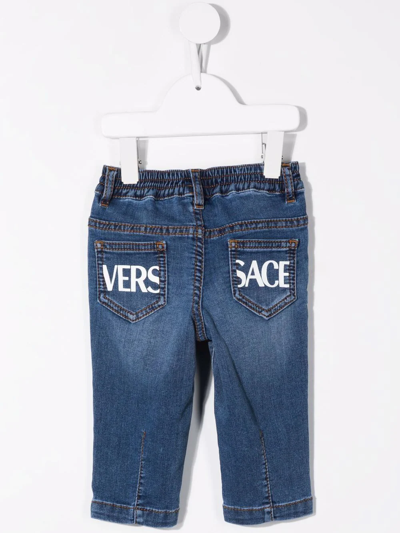 Shop Versace Logo-print Straight Leg Jeans In Blue