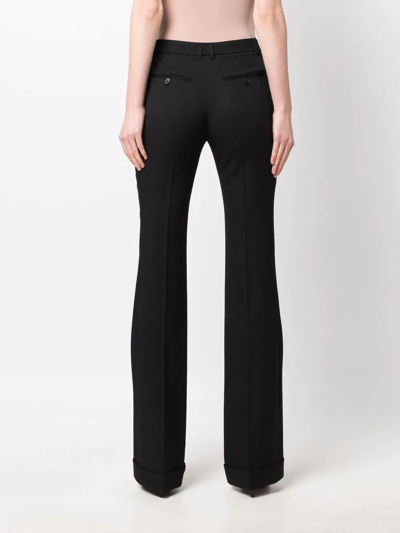 Shop Saint Laurent Pleat-detail Flared Tailored Trousers In Schwarz