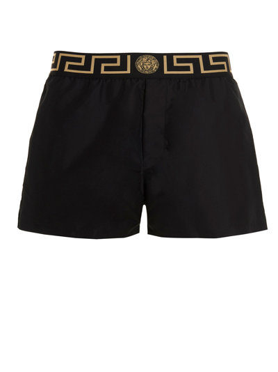 Shop Versace Logo Detailed Swim Shorts In Black