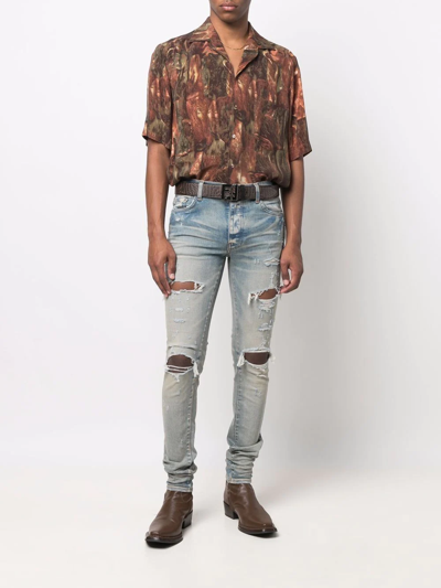 Shop Amiri Distressed Skinny Jeans In Blau