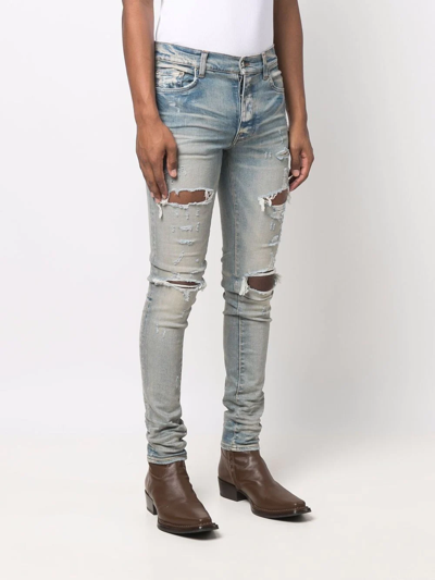 Shop Amiri Distressed Skinny Jeans In Blau