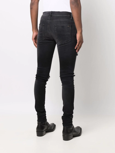 Shop Amiri Distressed Skinny Jeans In Schwarz