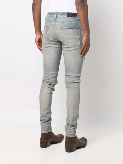 Shop Amiri Distressed Skinny Jeans In Blau