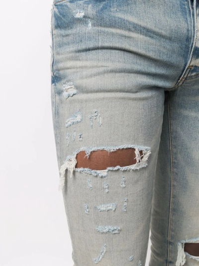 Shop Amiri Distressed Skinny Jeans In Blau