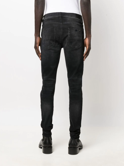 Shop Amiri Logo-embroidered Skinny Jeans In Schwarz