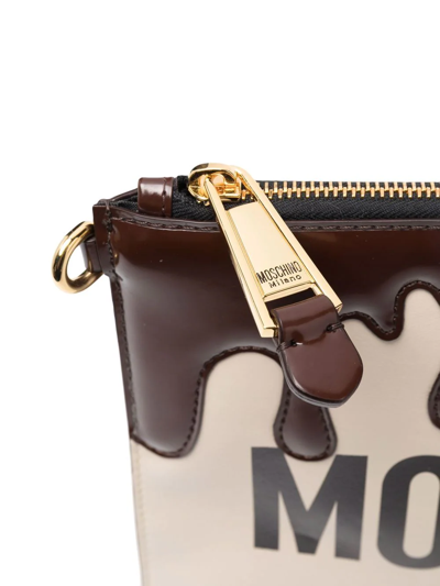 Shop Moschino Dripping Logo-print Clutch Bag In Neutrals
