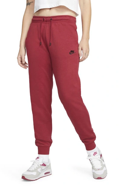 Shop Nike Sportswear Essential Fleece Pants In Pomegranate/ Black