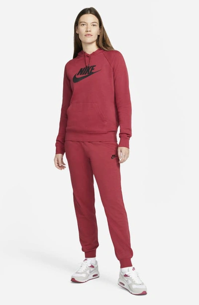 Shop Nike Sportswear Essential Fleece Pants In Pomegranate/ Black
