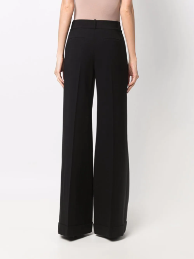 Shop Alice And Olivia High-waisted Flared Trousers In Black