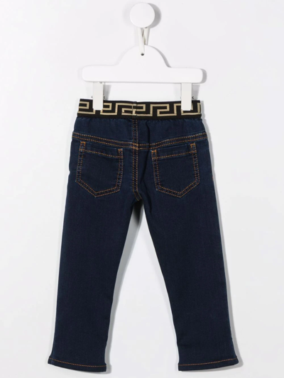 Shop Versace La Greca Print Jeans In Blue