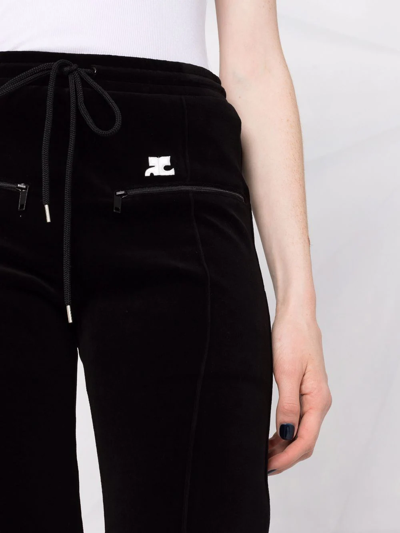 Shop Courrèges Embroidered-logo Flared Trousers In Black