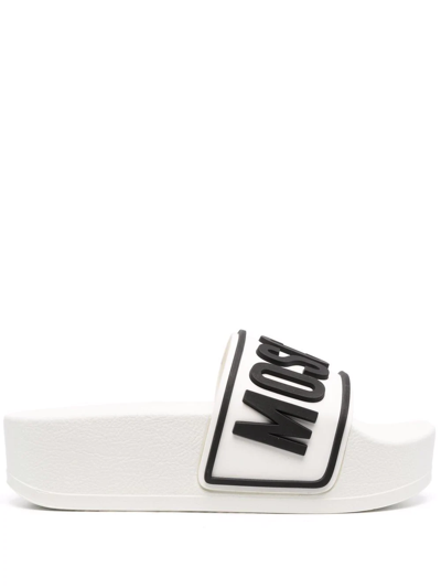 Shop Moschino Logo Embossed Platform Slides In White