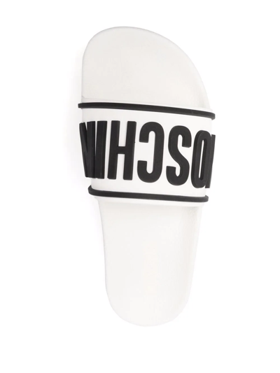 Shop Moschino Logo Embossed Platform Slides In White