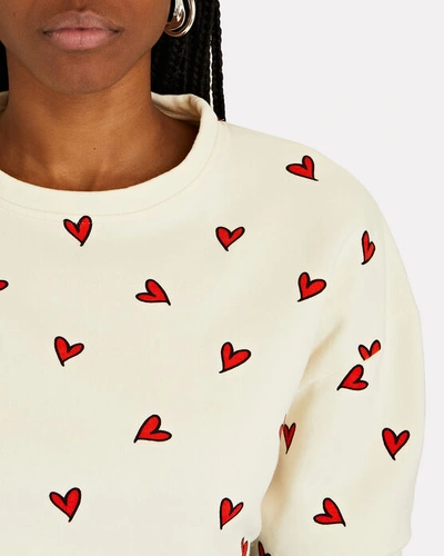 Shop Kule The Oversized All Over Heart Sweatshirt In Ivory