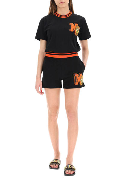 Shop Moschino Varsity Teddy Bear Sweatshorts In Black,orange
