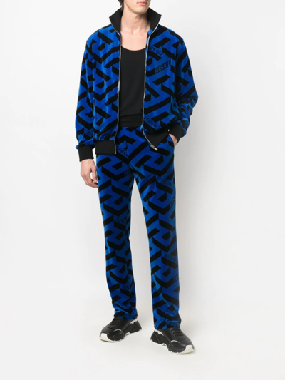 Shop Versace Geometric-pattern Track Pants In Schwarz