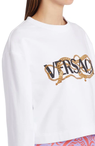 Shop Versace Chain Logo Graphic Cotton Crop Sweatshirt In Optical White