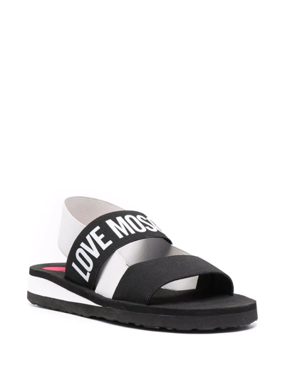 Shop Love Moschino Logo Print Strap Sandals In Schwarz
