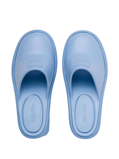 Shop Miu Miu Logo Embossed Mules In Blau